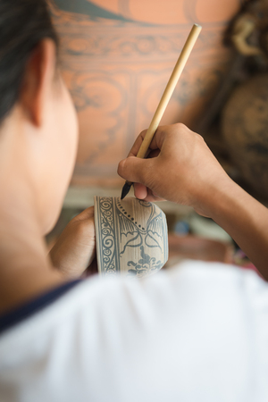 Closeup of people made painting on ceramic cupの写真素材