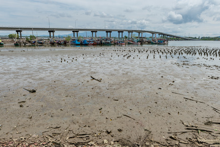 Grunge of sand on the beach with fishing harborの写真素材