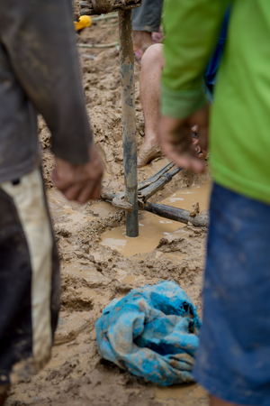 worker man making of soil punch, search for waterの写真素材