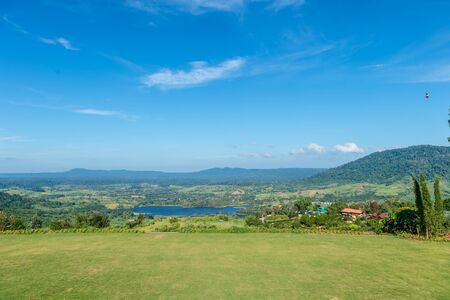 field grass with mountain and blue sky landscapeの写真素材