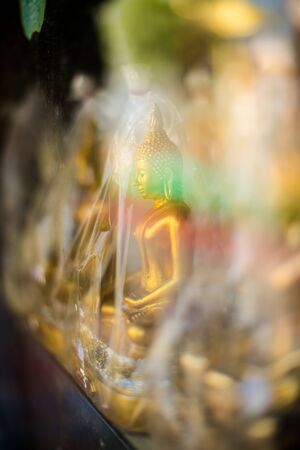Closeup of small buddha sculpture for sale in a templeの写真素材