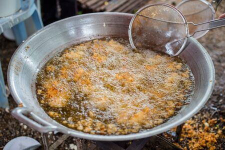 Closeup of chicken frying in a panの写真素材