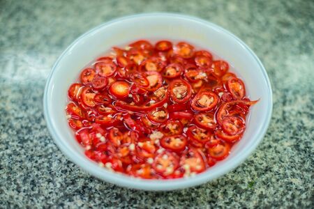 Closeup of red chili in ceramic cupの写真素材