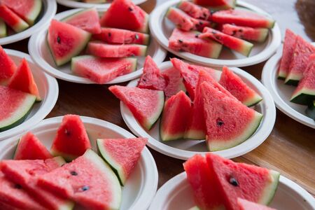 Closeup of watermelon slice on white dishの写真素材