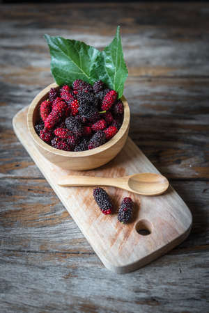 Mulberry fruit in a wood cup closeupの写真素材