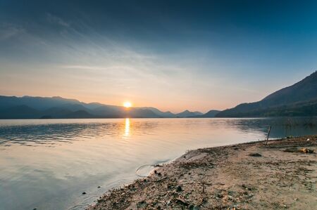 Mountain and lake with sunrise landscapeの写真素材