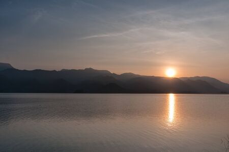 Mountain and lake with sunrise landscapeの写真素材