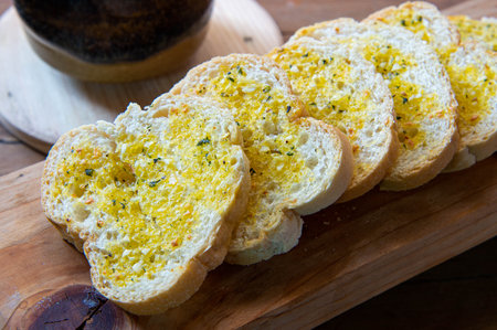 Closeups of garlic bread on chopping board.の写真素材