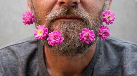 Brutal man with flowers in his beardの写真素材