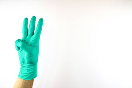 Male hand in medical glove on white background.