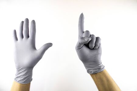 Male hand in medical glove on white background.の写真素材