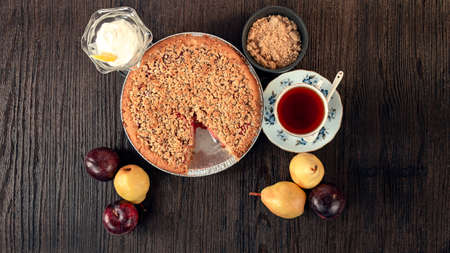 very tasty homemade pumpkin cake with pumpkin seeds and cup of tea and fruitsの写真素材