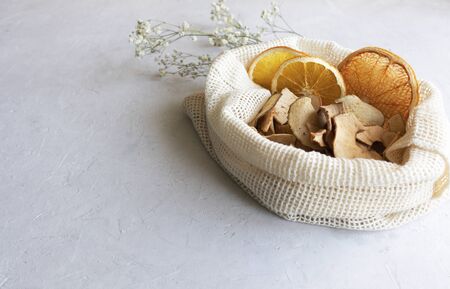 Eco bag in the hole with fruit chips, apple chips, homemade dried banana chips, closeupの写真素材