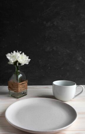 empty plate and cup on a wooden background, mock up for adding food or inscriptionsの写真素材