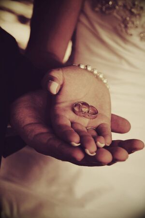 Hand of the groom and the bride with wedding ringsの写真素材