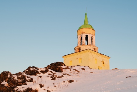 Watchtower on a grief  Lisya located in a city Nizhniy Tagil, in Russia,  in beams of the winter morning sunの写真素材