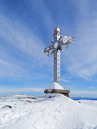  Cross at mountain top in clear winter day, Russia, Siberiaの写真素材