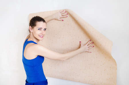 Beautiful young woman doing repairs, glues Wallpaperの写真素材