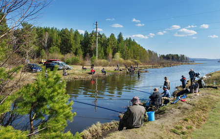 MIDDLE URALS, RUSSIA - MAY 5, 2016: Many fishermen catch fish in the mouth of the river Kanava during the spring fishing activity. Middle Ural. Russiaのeditorial素材