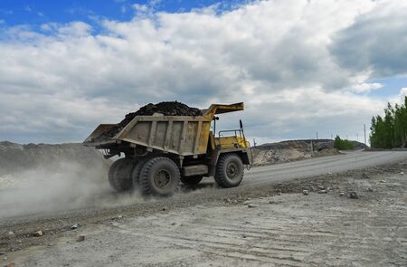 PERVOURALSK, RUSSIA - JUNE 06, 2017: BelAZ truck transports ore on a dirt roadのeditorial素材