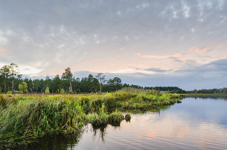Beautiful scenery. Sunset on the lake in early autumnの写真素材