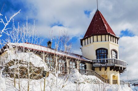 SVERDLOVSK REGION, RUSSIA - MARCH 2, 2018: Beautiful restaurant building on top of the mountain. Ski...
