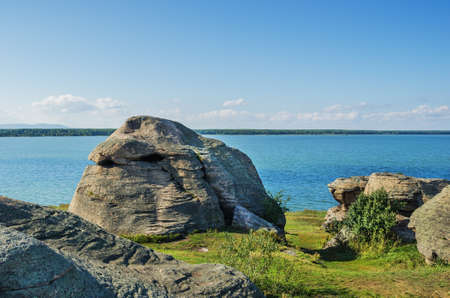 Rocks on the shore of lake Big Allaki on a clear summer day. Russia. Ural. Chelyabinsk region.の写真素材