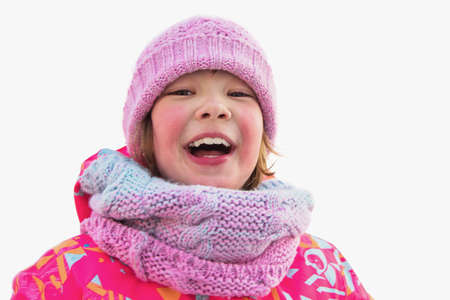 Portrait of a baby girl in winter clothes, isolated on a white backgroundの写真素材