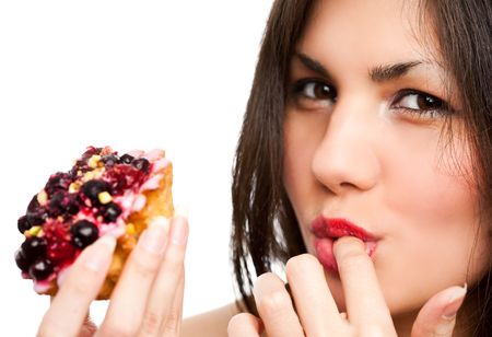 Young beautiful woman with a cake. Close-up studio portrait. isolated on whiteの写真素材