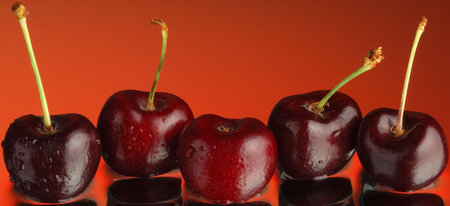 Sweet cherry and water on a mirror