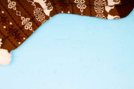 Beautiful winter warm Christmas socks with a New Year's pattern on a blue wooden table background. Greeting card with copy space for text. Original design and texture. Best Christmas gift. Close-upの写真素材