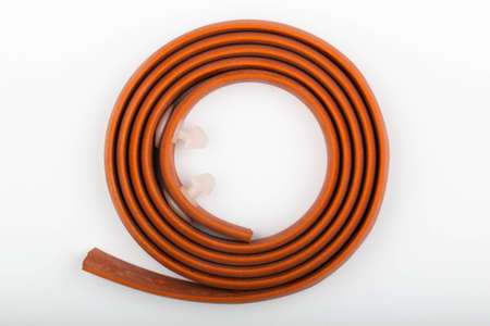 Red hemostatic rubber medical tourniquet for stopping bleeding on a white background. Tool for bleeding control. Bleed kit for first aid. Stop blood. Isolated. Top view. Close-upの写真素材