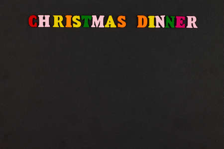 Christmas Dinner menu template on black background. Copy space for text. Christmas menu background concept. Design card for a restaurant menu for a Christmas evening. Colorful letters. Close-upの写真素材
