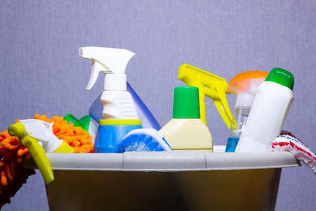 Basket with detergents on the table. Harmless dishwashing detergent. Detergent for washing floors. Household cleaning chemicals. Chemical substances. Water-soluble substances the chemical industry.の写真素材