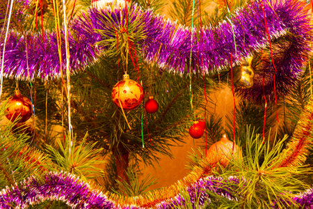The Christmas tree is decorated with glass Christmas toys. Beautiful New Year decorations on the New Year tree. Colorful Christmas decorations. Colored bright glass balls. Holiday wallpaperの写真素材
