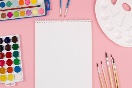 Back to school. Brushes, paints and palette on the table. A set of brushes of different sizes, bright multi-colored paints for drawing on a beautiful pink background. Ð¡Ð¾ÑÑ spaceの写真素材