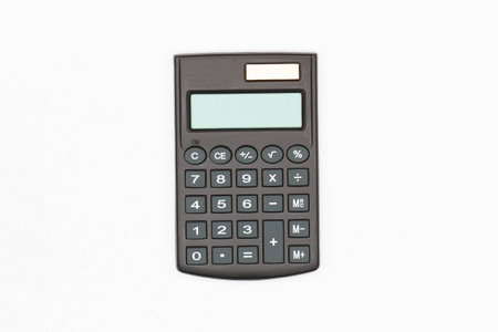 Calculator with big buttons with empty digital screen on a white background. Isolated. Solar powered financial calculator. Electronic machine for math calculations. Business officeの写真素材