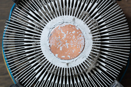 Very dirty cooling radiator for a computer processor. Dusty aluminum cooler for a CPU microchip on a computer motherboard with traces of cooling grease. The part for cleaning. Servの写真素材