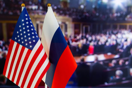 Flags of the USA and France on a blurred background of the conference hallの写真素材