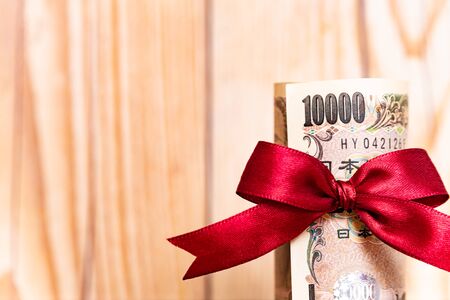 Money gift with red ribbonの写真素材