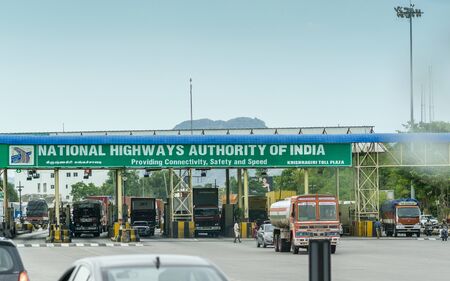 Krishnagiri, Tamil Nadu / India - 9th August 2019: Private and commercial vehicles waiting in line to pass through toll plaza in india, fast tag lanes, national highway authority of indiaのeditorial素材