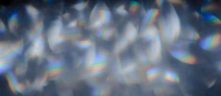 Soft colorful bokeh background. Luminous garlands of electric lights. Copy space to add text. Saturated colors. Blurry abstraction. Gentle tone. Dark night. Festive party in city. Defocus effect.の写真素材