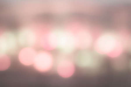 Soft colorful bokeh background. Luminous garlands of electric lights. Copy space to add text. Saturated colors. Blurry abstraction. Gentle tone. Dark night. Festive party in city. Defocus effect.の写真素材