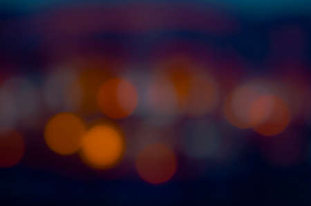 Soft colorful bokeh background. Luminous garlands of electric lights. Copy space to add text. Saturated colors. Blurry abstraction. Gentle tone. Dark night. Festive party in city. Defocus effect.の写真素材