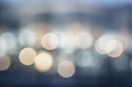 Soft colorful bokeh background. Luminous garlands of electric lights. Copy space to add text. Saturated colors. Blurry abstraction. Gentle tone. Dark night. Festive party in city. Defocus effect.の写真素材