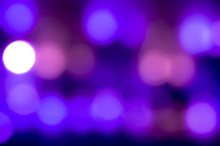 Soft colorful bokeh background. Luminous garlands of electric lights. Copy space to add text. Saturated colors. Blurry abstraction. Gentle tone. Dark night. Festive party in city. Defocus effect.の写真素材