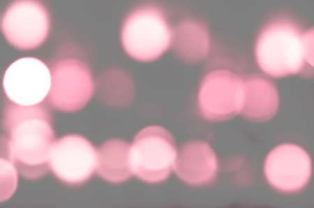 Soft colorful bokeh background. Luminous garlands of electric lights. Copy space to add text. Saturated colors. Blurry abstraction. Gentle tone. Dark night. Festive party in city. Defocus effect.の写真素材