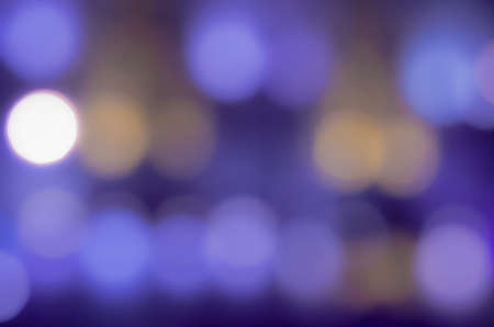 Soft colorful bokeh background. Luminous garlands of electric lights. Copy space to add text. Saturated colors. Blurry abstraction. Gentle tone. Dark night. Festive party in city. Defocus effect.の写真素材