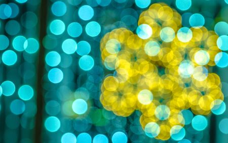 Soft, large, colorful bokeh different colors. Fill the entire background. Tender tones yellow, green, blue. Snowflake contour on the right side of the image.の写真素材