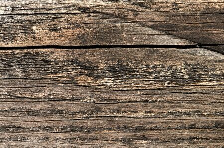 Fragment of the wall of the old wooden house in the Belorussian village. Beautiful vintage background of wooden boards with colorful texture. Copy space to add your text.の写真素材